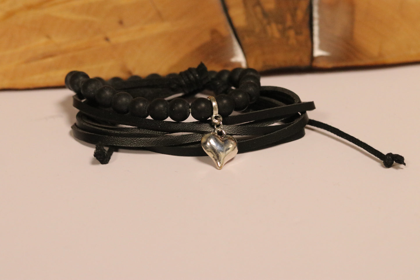 Black beaded bracelet with a heart charm
